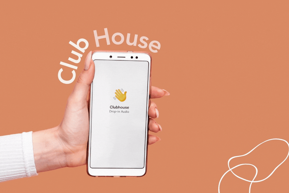 Hand holding an iPhone with the ClubHouse app loaded on the screen.